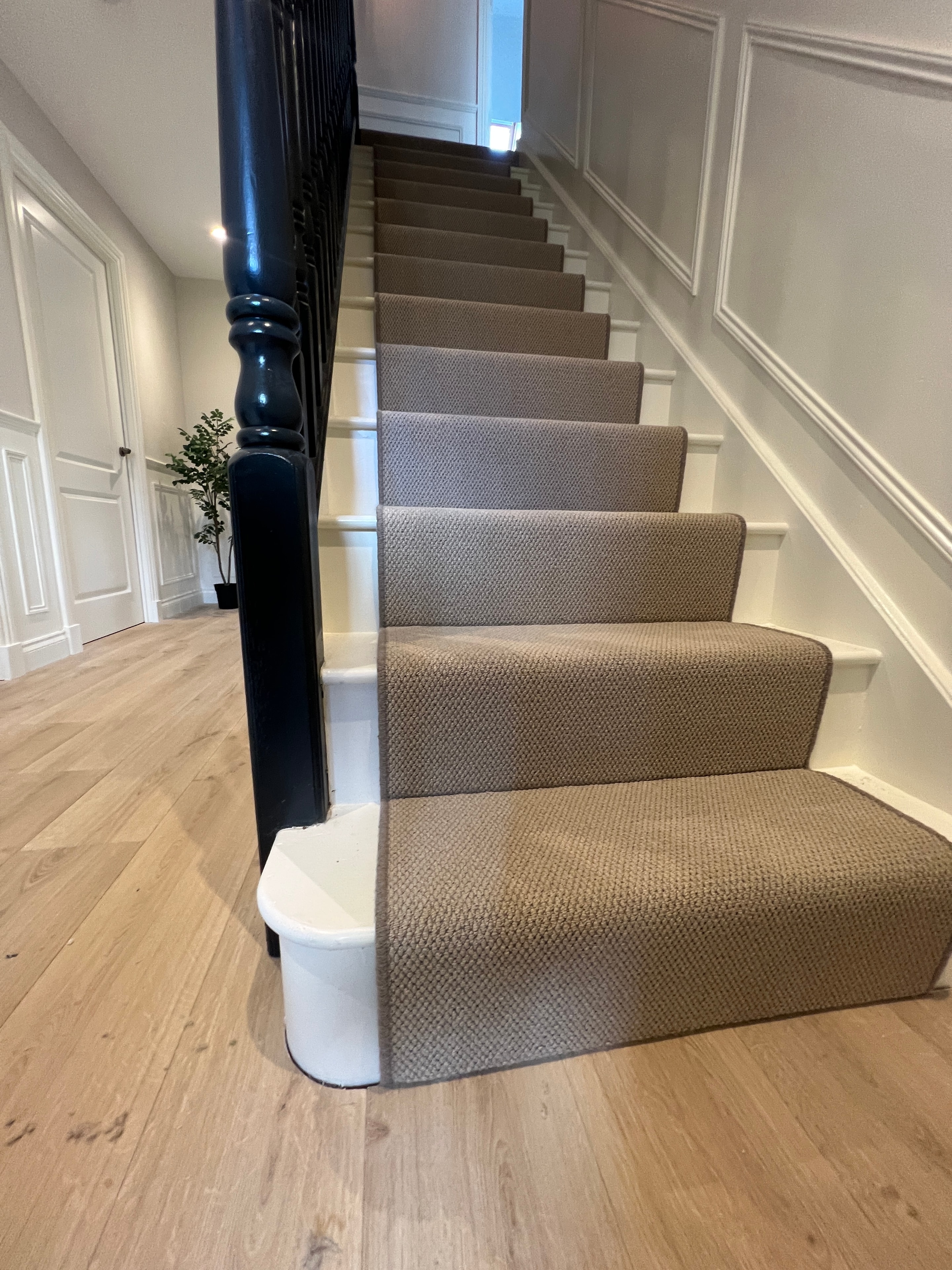 Modern staircase with grey carpet runner