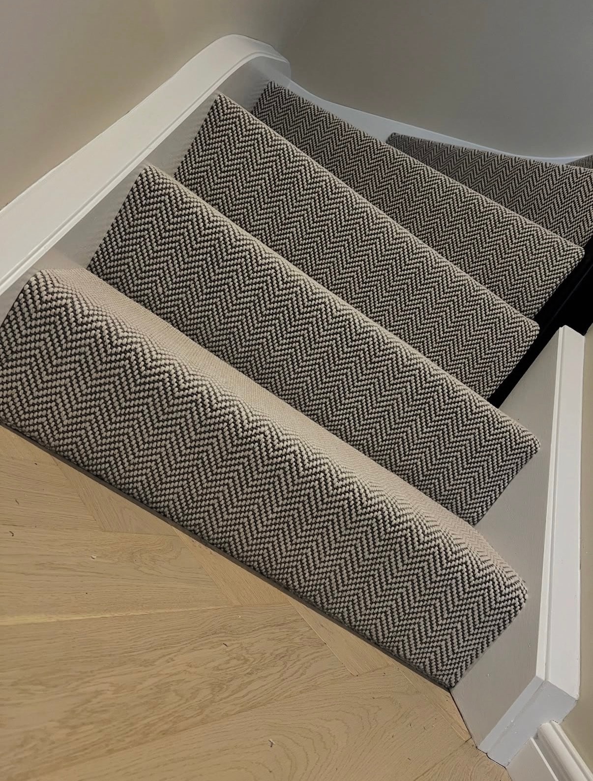 Close-up of herringbone patterned stair runner carpet