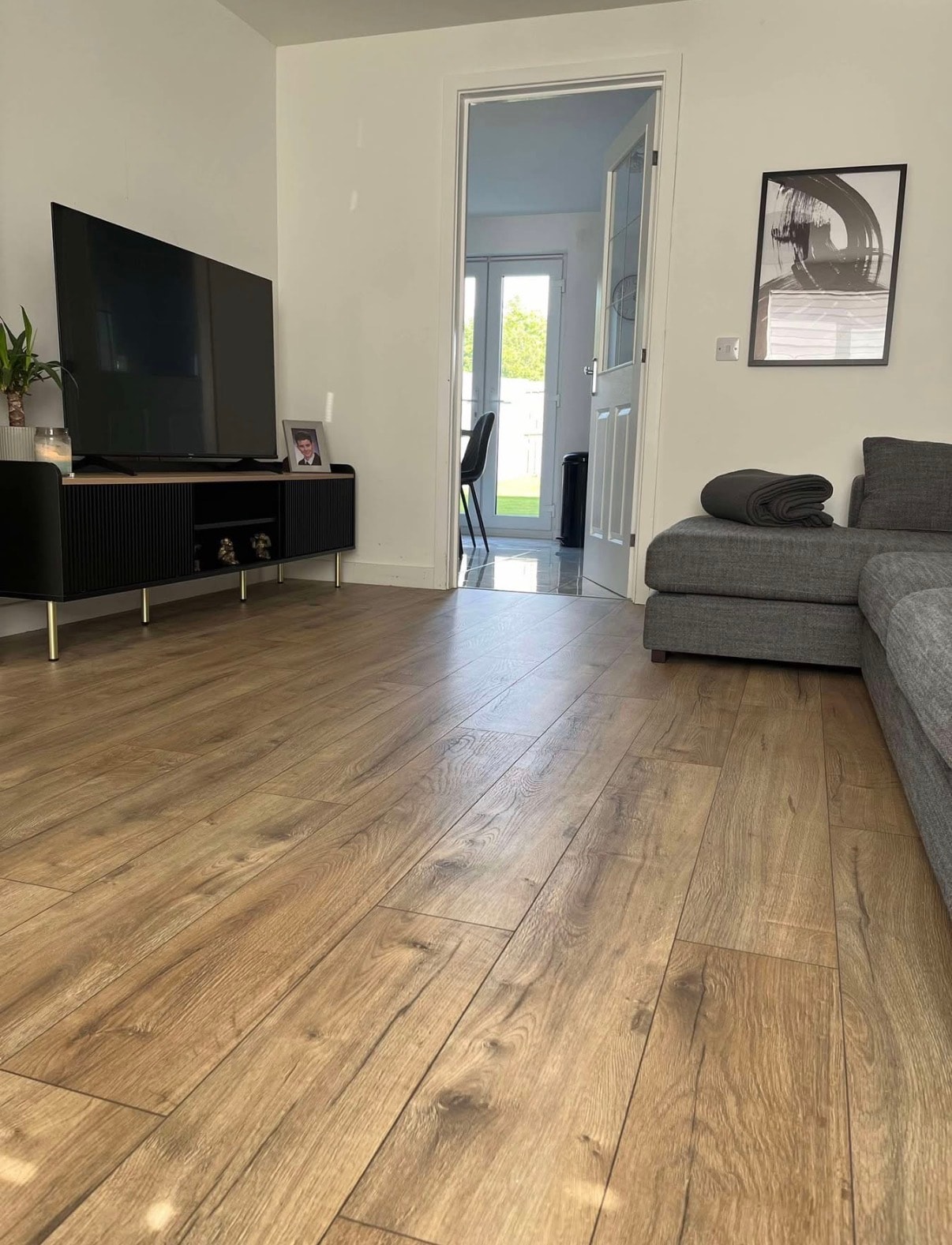 Modern living room with warm oak laminate flooring