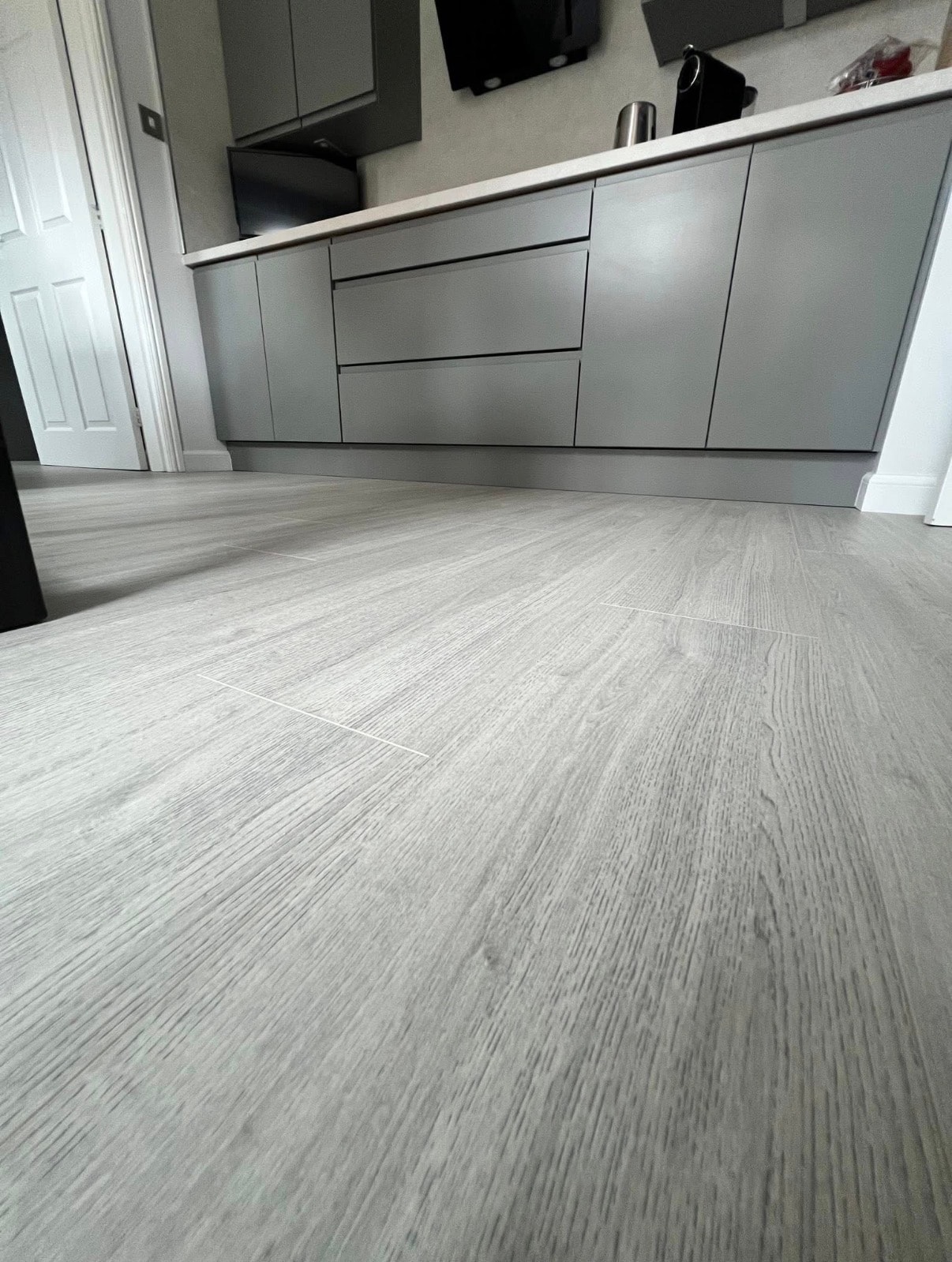 Kitchen with light wood-effect vinyl flooring
